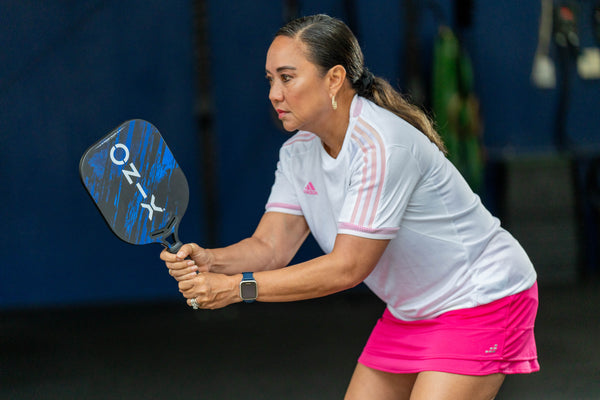 female pickleball player holding malice pickleball paddle